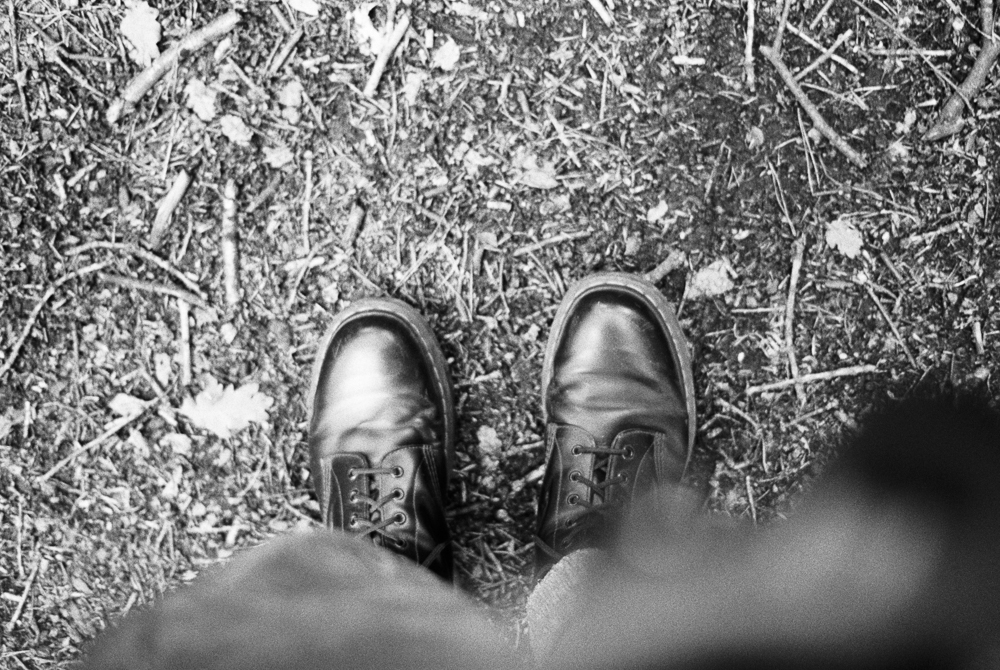 Boots, earth and twigs, black and white, 2021, Nikon FE HP5+